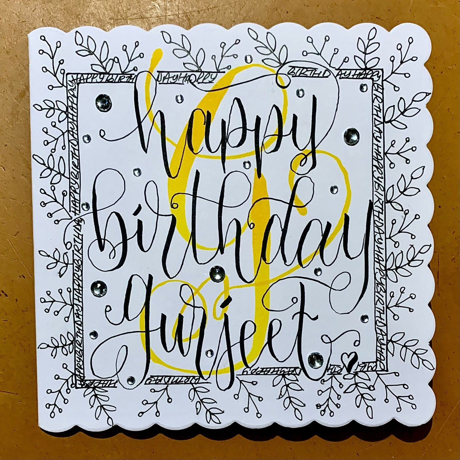 Happy birthday card with bold yellow flourish and hand-drawn botanical border.