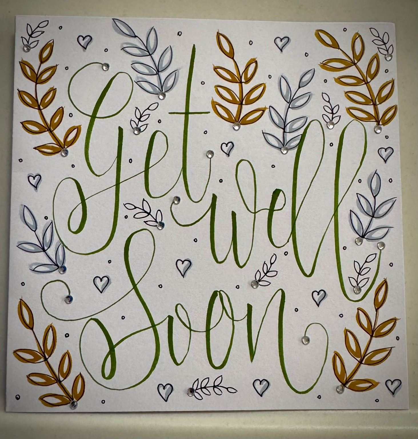 Get well soon card with hand lettering and botanical details.